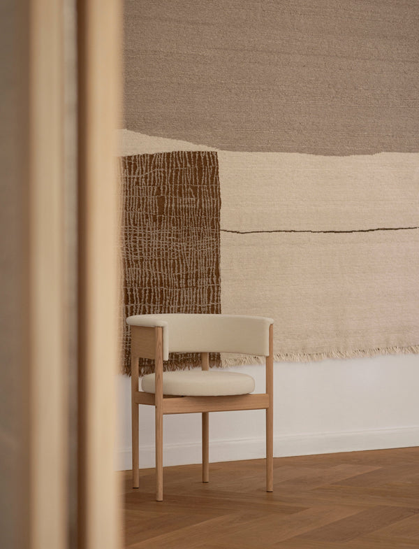 Minimalist interior with a chair and textured wall